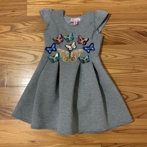 Fit and flare scuba fabric dress with sequin butterfly detail.